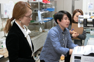 学生から説明を受ける渡邉室長補佐